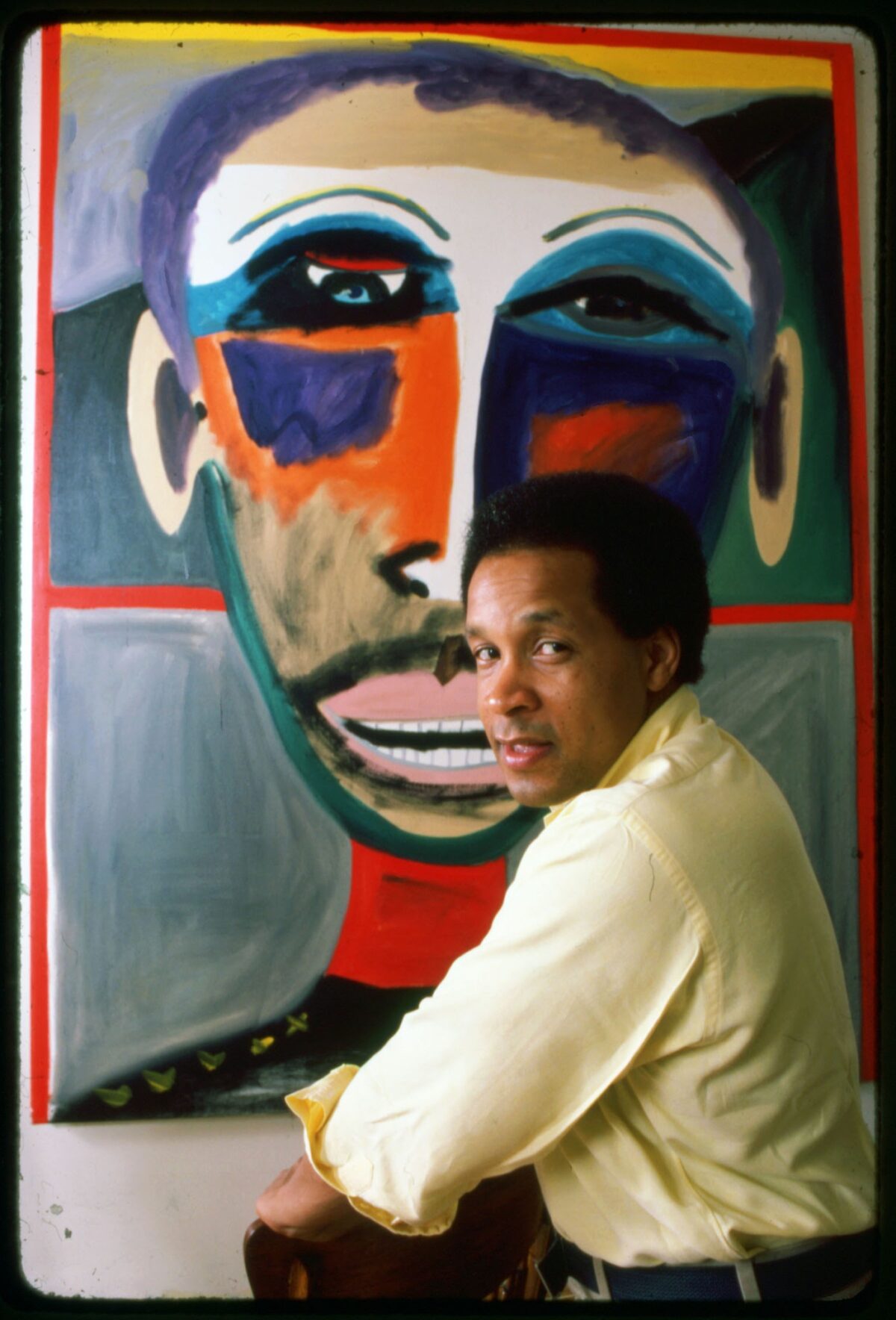 Portrait of American artist Frederick J Brown (1945 - 2012) as he poses in front of one of his paintings, New York, 1984. (Photo by Anthony Barboza/Getty Images)